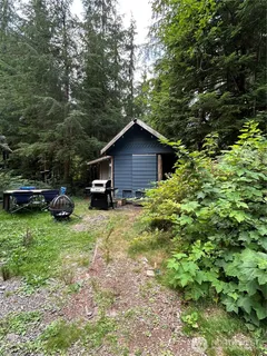 a car parked in front of a house with a small yard