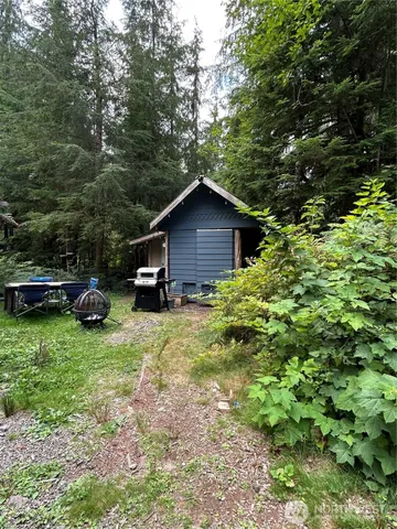 a car parked in front of a house with a small yard