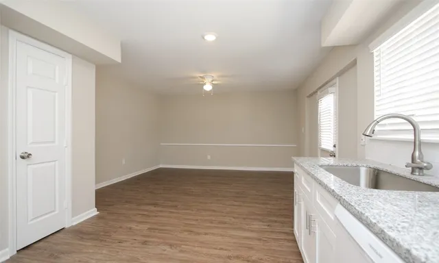 a kitchen with granite countertop a sink and a stove
