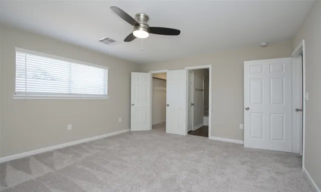 an empty room with closet area