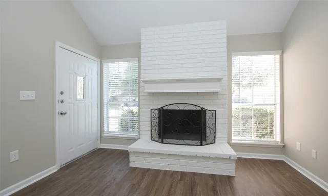 a view of a livingroom with a fireplace and window