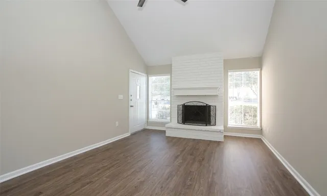 a view of a room with wooden floor and a window