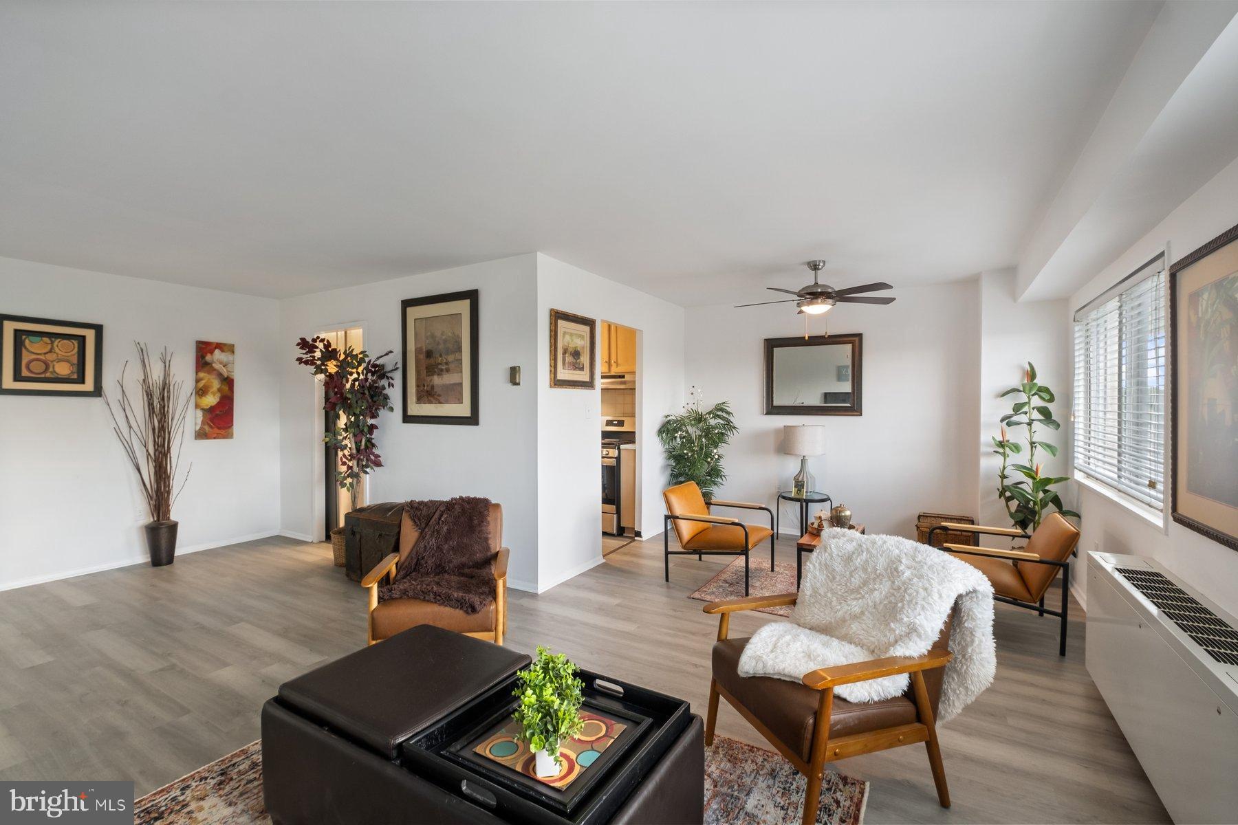 1111 University Boulevard West, Unit 817 Silver Spring, MD 20902 - Photo 1 of 26 a living room with furniture and a wooden floor