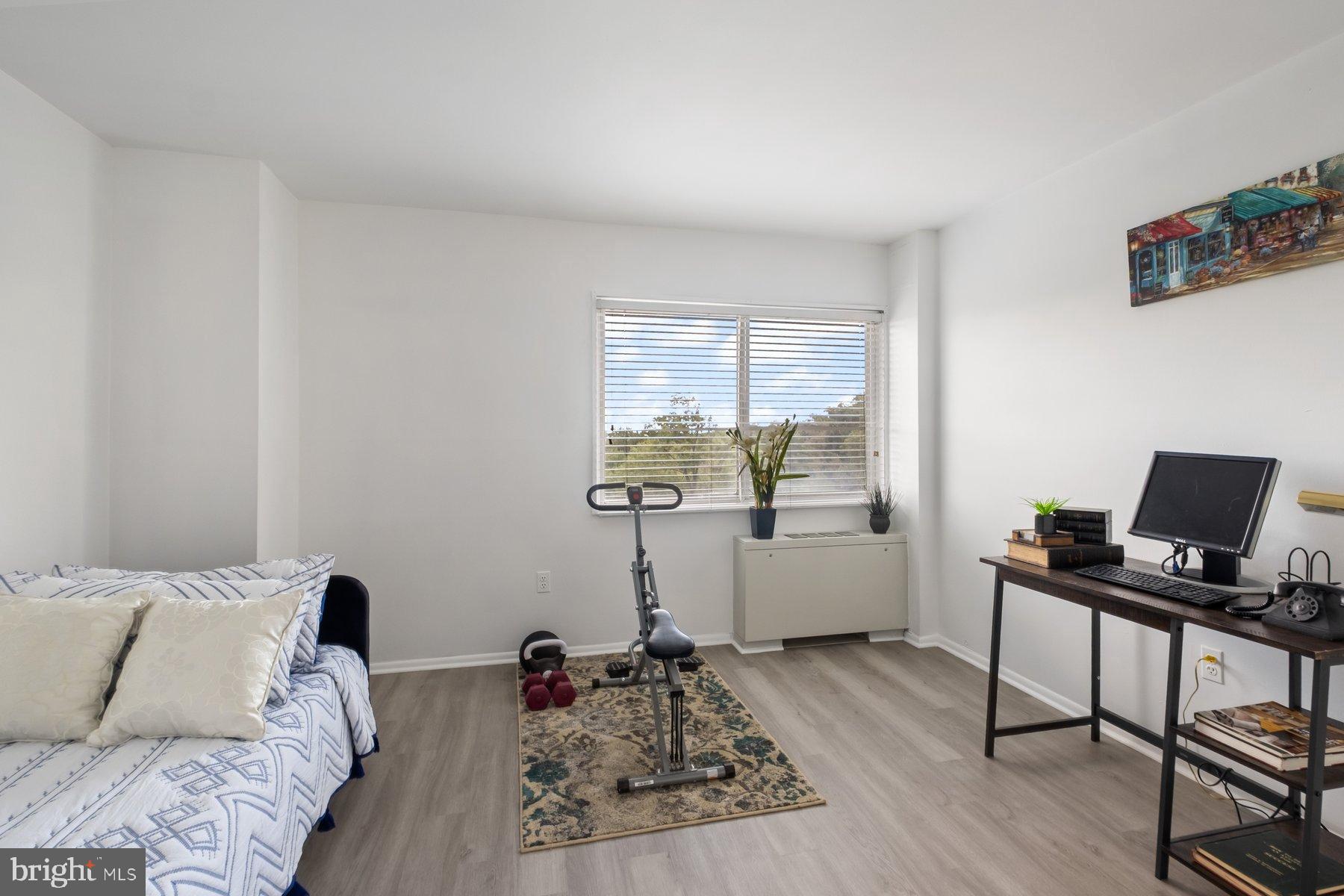 1111 University Boulevard West, Unit 817 Silver Spring, MD 20902 - Photo 14 of 26 a bedroom with furniture and a window