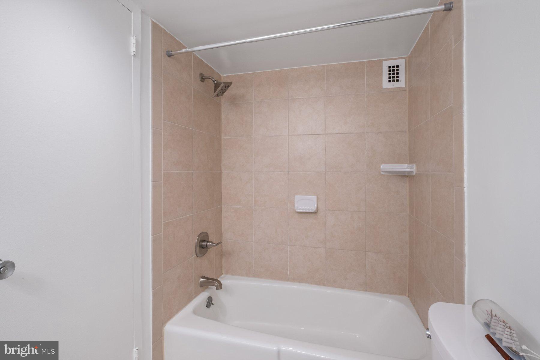 1111 University Boulevard West, Unit 817 Silver Spring, MD 20902 - Photo 17 of 26 a bathroom with a bathtub