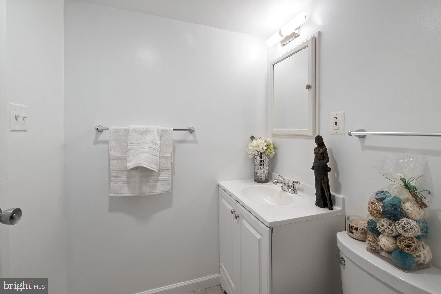 1111 University Boulevard West, Unit 817 Silver Spring, MD 20902 - Photo 21 of 26 a bathroom with a sink and mirror