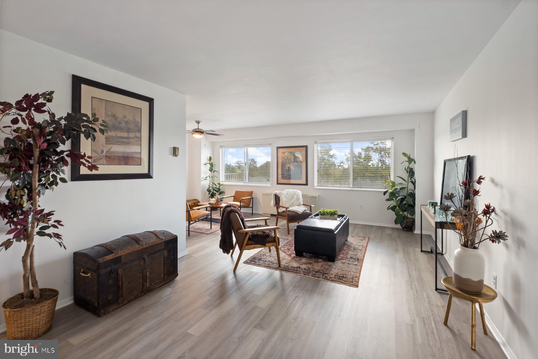 1111 University Boulevard West, Unit 817 Silver Spring, MD 20902 - Photo 5 of 26 a living room with furniture large window and wooden floor
