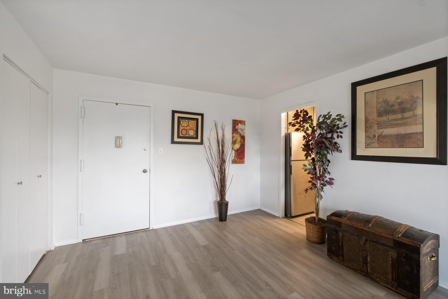 1111 University Boulevard West, Unit 817 Silver Spring, MD 20902 - Photo 6 of 26 a view of a livingroom with furniture and a hallway