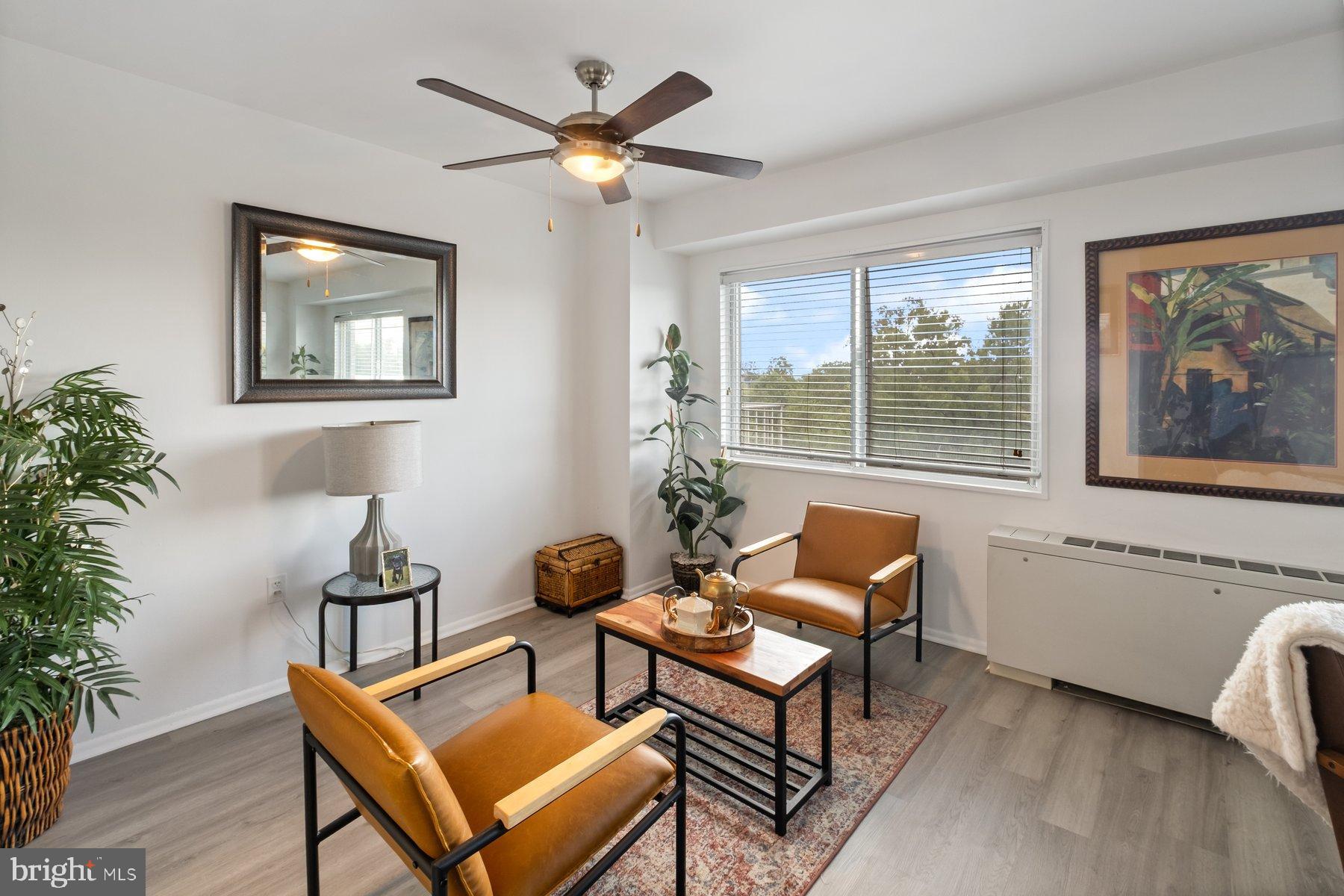 1111 University Boulevard West, Unit 817 Silver Spring, MD 20902 - Photo 8 of 26 a living room with furniture and a large window