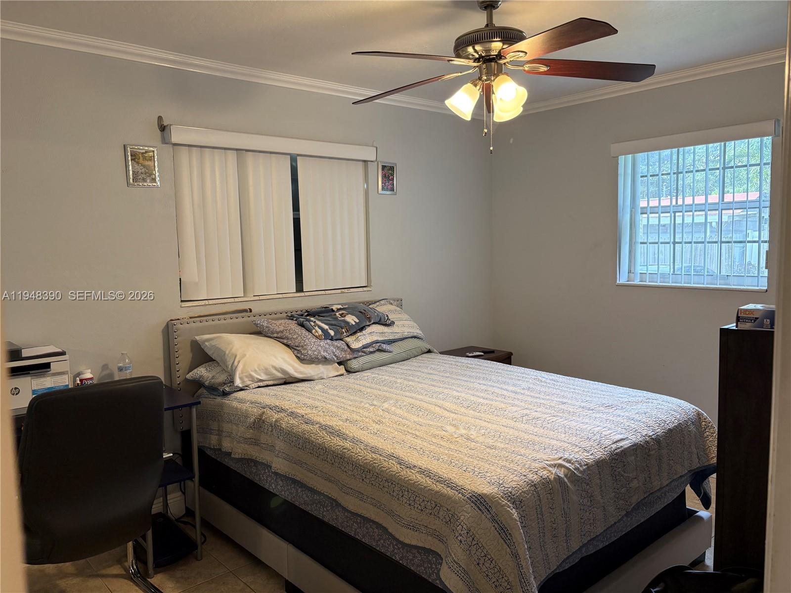 330 North 69th Way Hollywood, FL 33024 - Photo 11 of 20 a bedroom with a bed and a chandelier