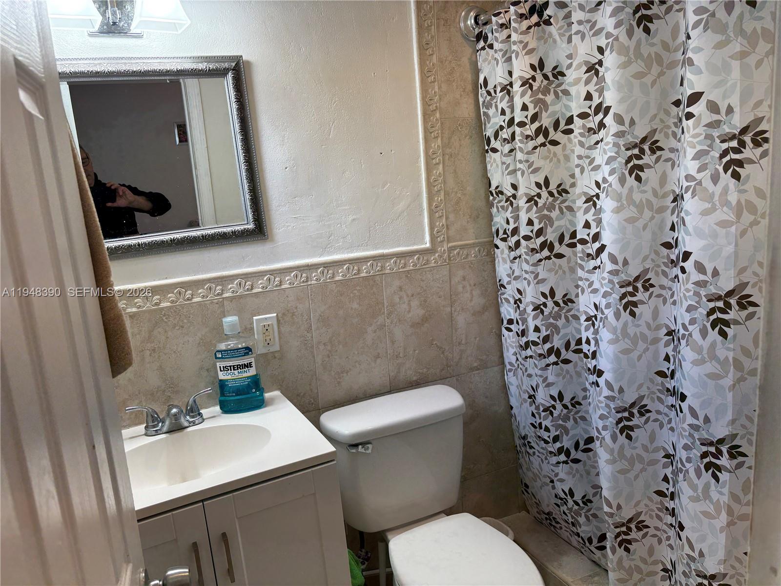 330 North 69th Way Hollywood, FL 33024 - Photo 12 of 20 a white toilet sitting next to a bathroom sink