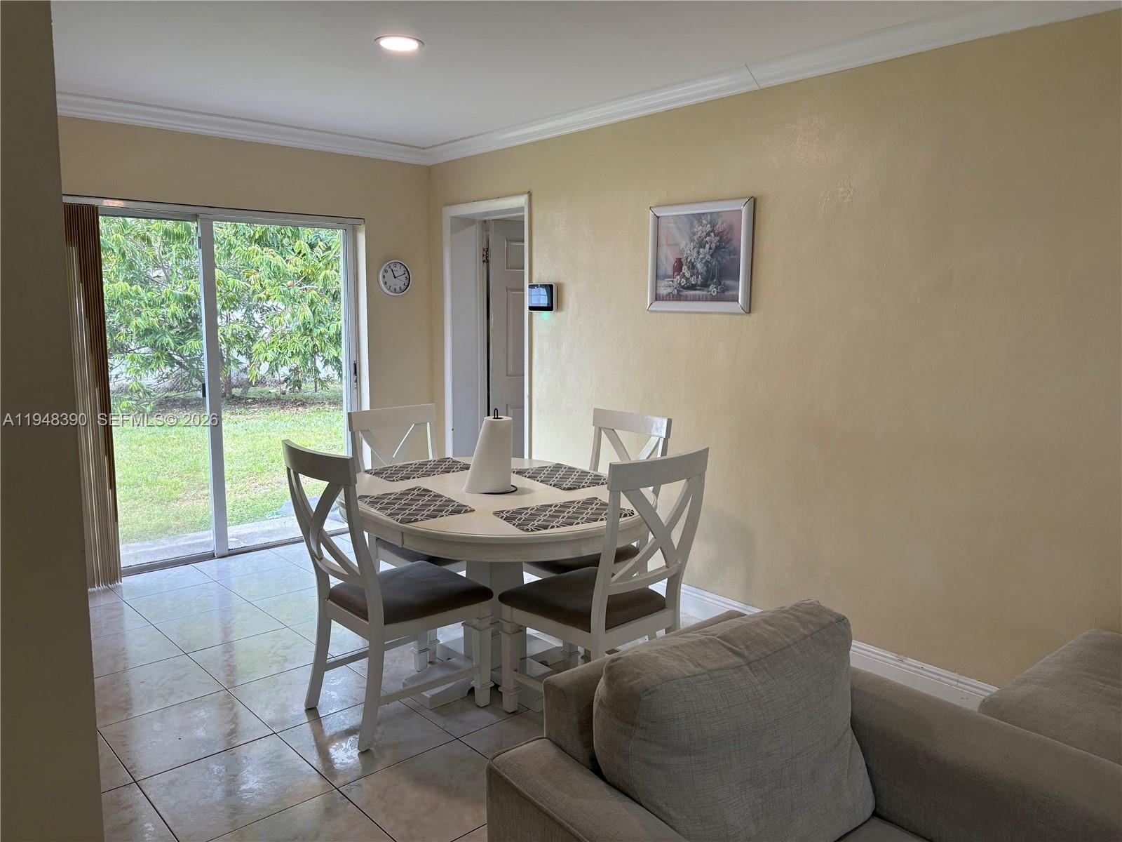 330 North 69th Way Hollywood, FL 33024 - Photo 4 of 20 a view of a dining room with furniture and a potted plant