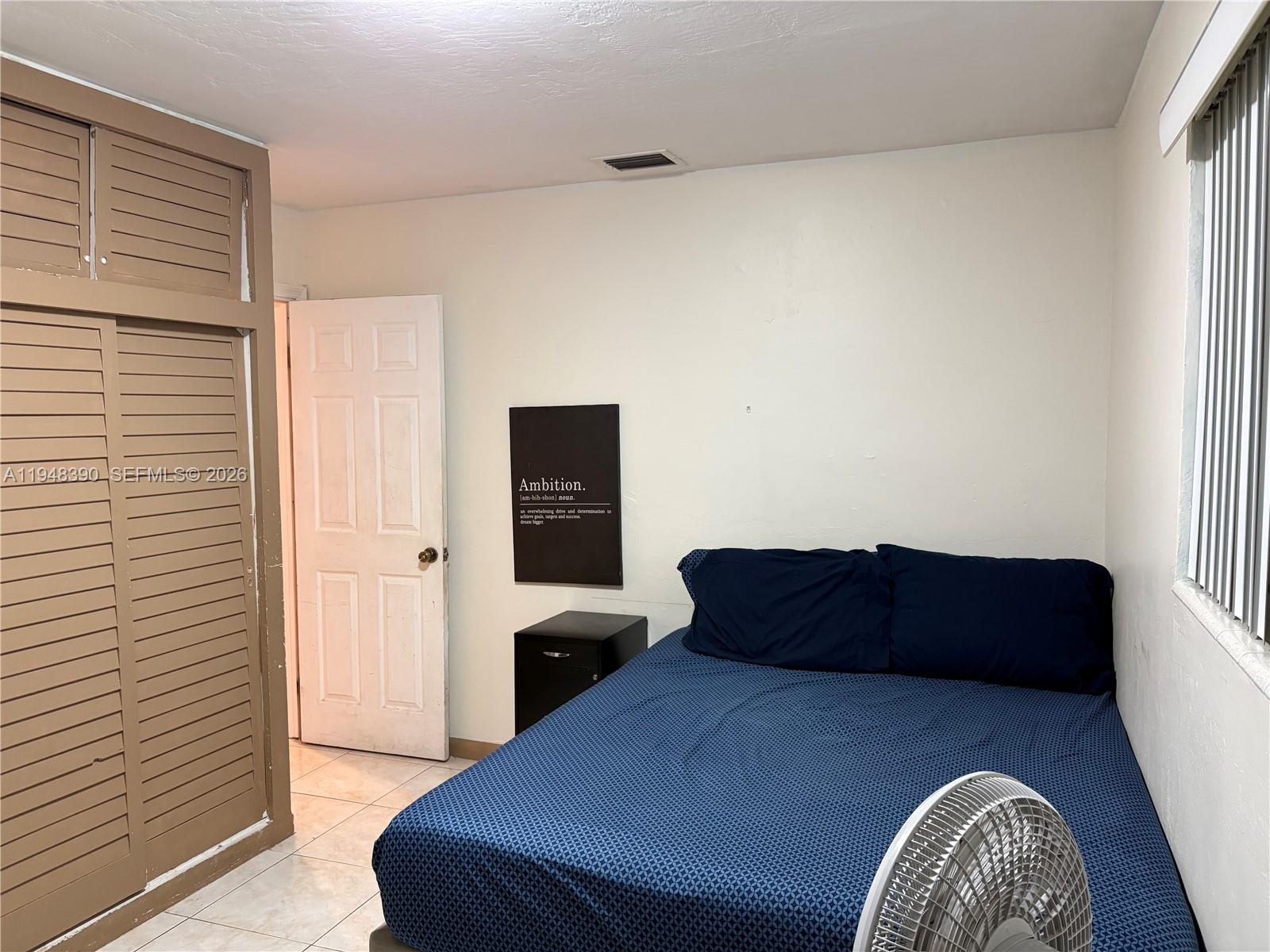 330 North 69th Way Hollywood, FL 33024 - Photo 9 of 20 a bedroom with a bed and wooden floor