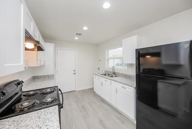 a kitchen with a sink stove and refrigerator