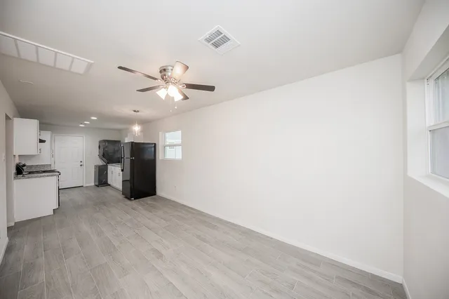 a view of a kitchen with a sink and a ceiling fan