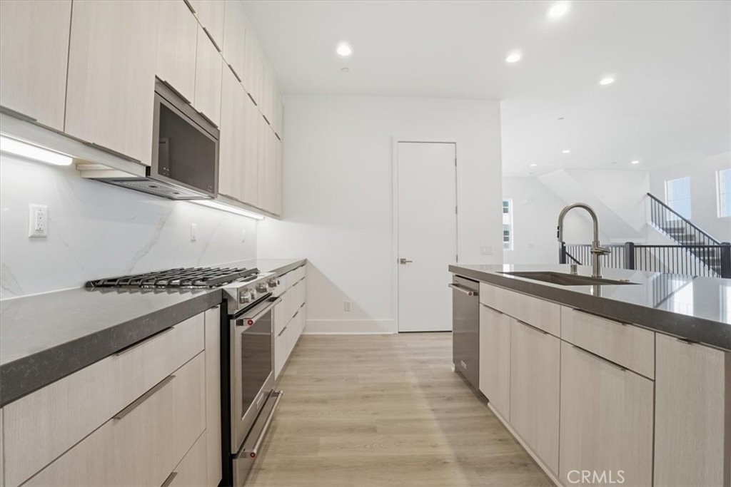 8 Remy Lane Montebello, CA 90640 - Photo 11 of 61 a kitchen with stainless steel appliances granite countertop a stove and a sink