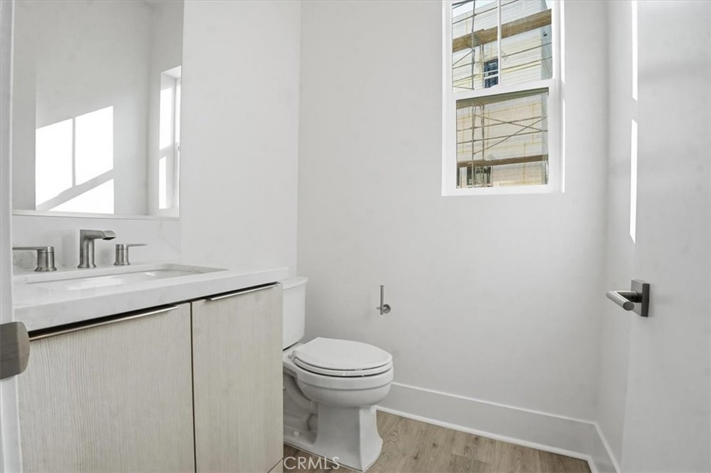 8 Remy Lane Montebello, CA 90640 - Photo 18 of 61 a bathroom with a toilet sink vanity and mirror