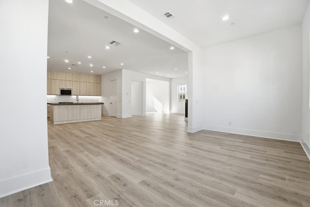 8 Remy Lane Montebello, CA 90640 - Photo 19 of 61 a view of kitchen with kitchen island a sink wooden floor and a large window