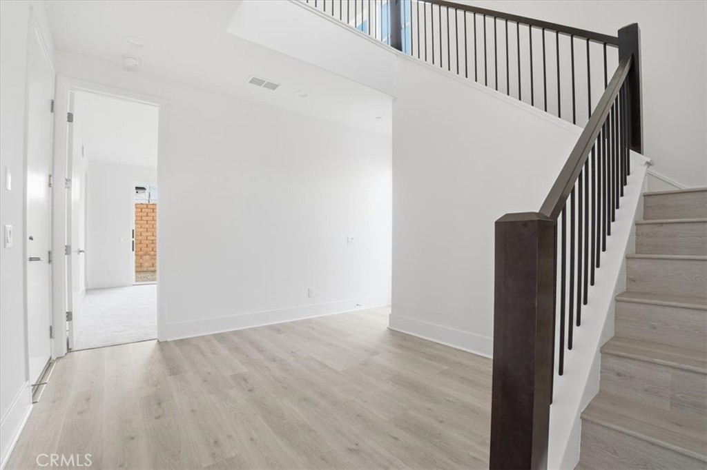 8 Remy Lane Montebello, CA 90640 - Photo 22 of 61 a view of a hallway with wooden floor and entryway