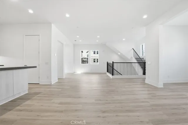 an empty room with windows and closet