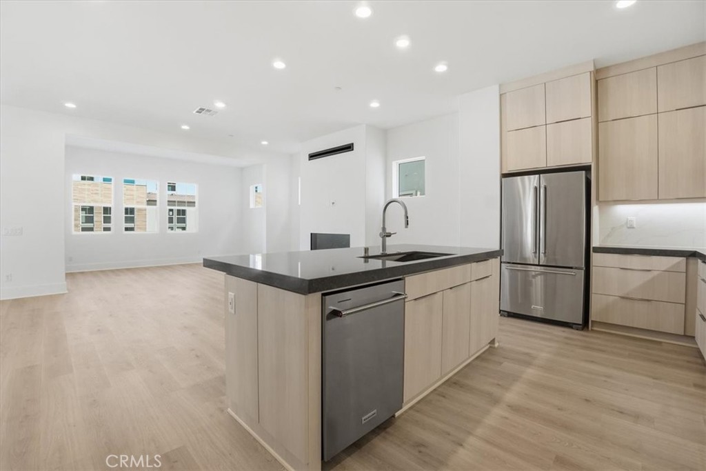 8 Remy Lane Montebello, CA 90640 - Photo 4 of 61 a kitchen with stainless steel appliances granite countertop a refrigerator sink and white cabinets