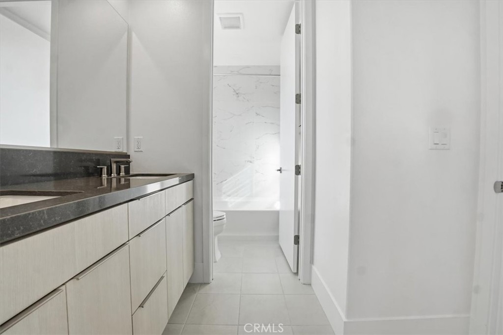 8 Remy Lane Montebello, CA 90640 - Photo 46 of 61 a bathroom with a granite countertop sink and a mirror