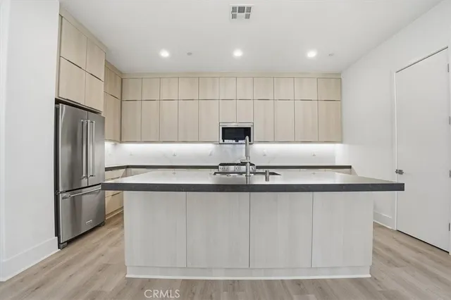 a kitchen with granite countertop a sink and cabinets
