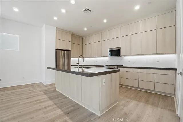 a kitchen with granite countertop a stove and a sink