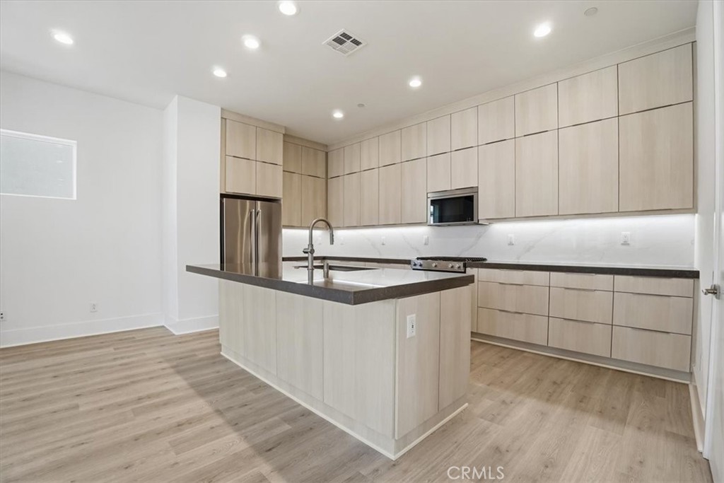8 Remy Lane Montebello, CA 90640 - Photo 7 of 61 a kitchen with stainless steel appliances granite countertop a stove a sink and a refrigerator