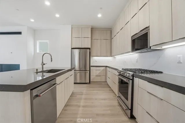 a kitchen with stainless steel appliances granite countertop a stove and a sink