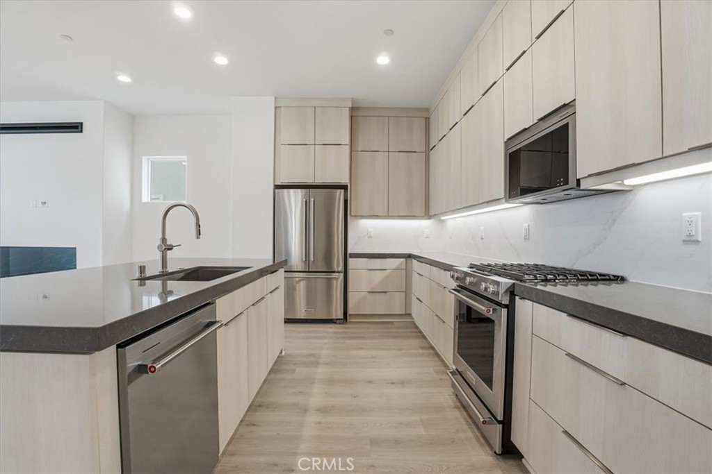 8 Remy Lane Montebello, CA 90640 - Photo 9 of 61 a kitchen with granite countertop a sink stove and refrigerator