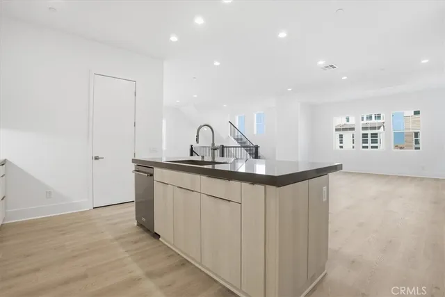 a view of a refrigerator in kitchen and wooden floor