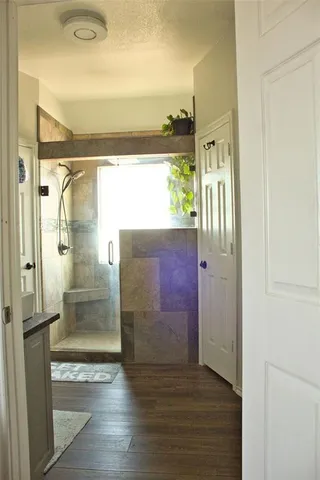 a view of a bathroom with a glass door shower and a sink