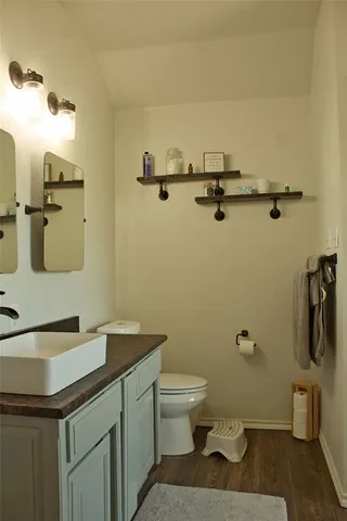 a bathroom with a sink a toilet and a mirror