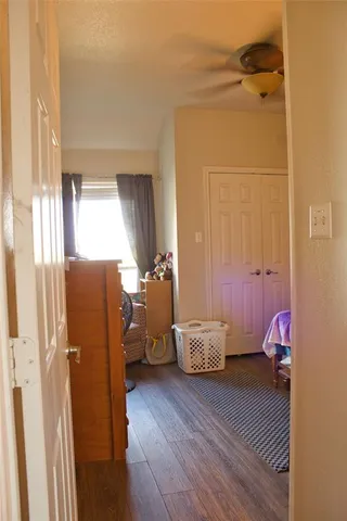 a view of a room that has a couch and a dresser with wooden floor