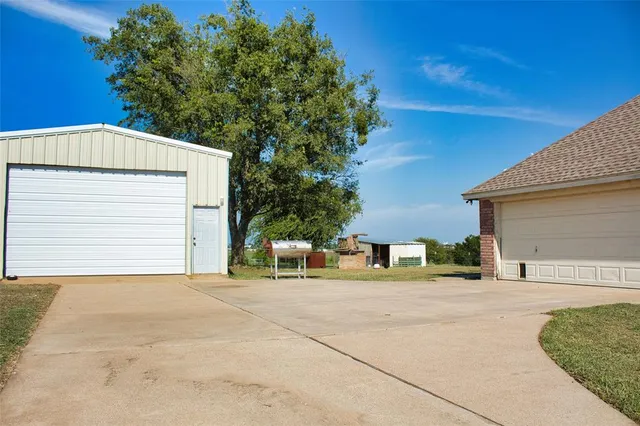 a view of a house with a yard and garage