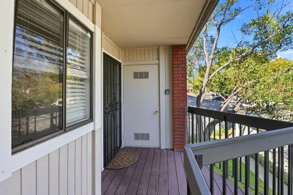 a view of a balcony with wooden floor