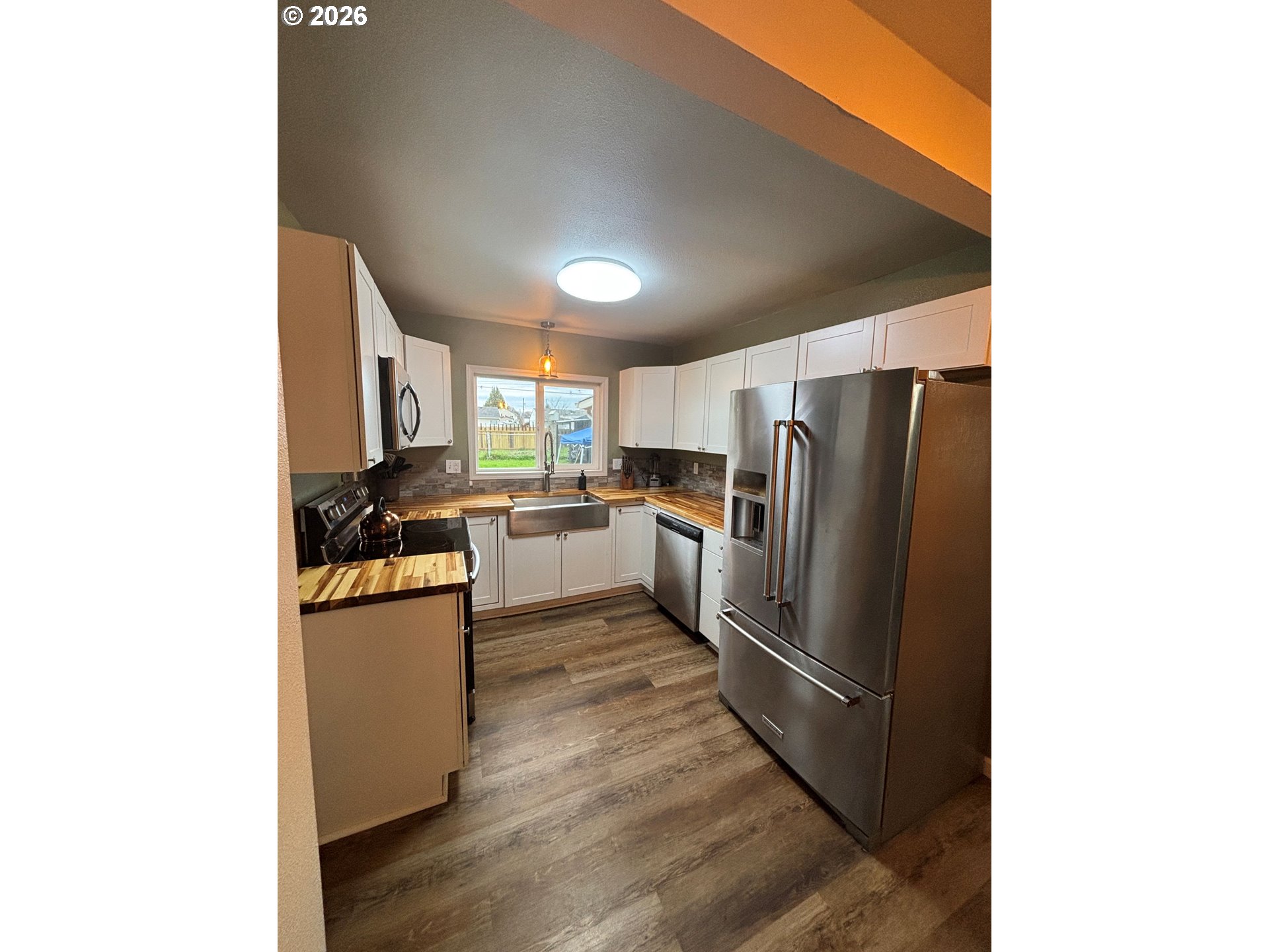 337 Cypress Street Longview, WA 98632 - Photo 5 of 16 a kitchen with granite countertop a refrigerator stove top oven and sink