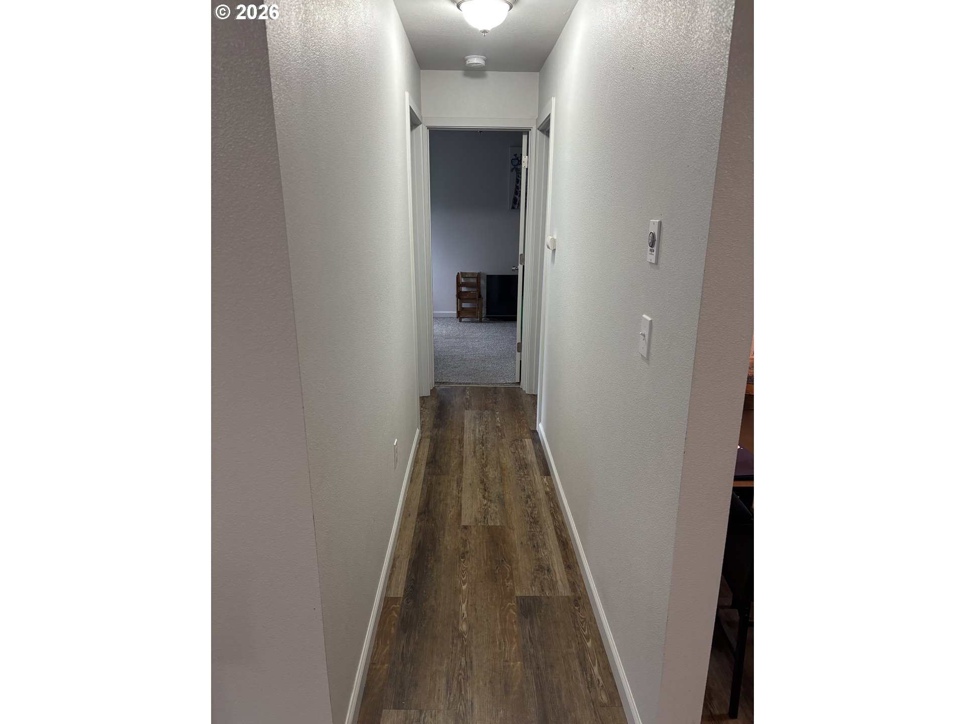 337 Cypress Street Longview, WA 98632 - Photo 8 of 16 a view of a hallway with wooden floor and a bathroom