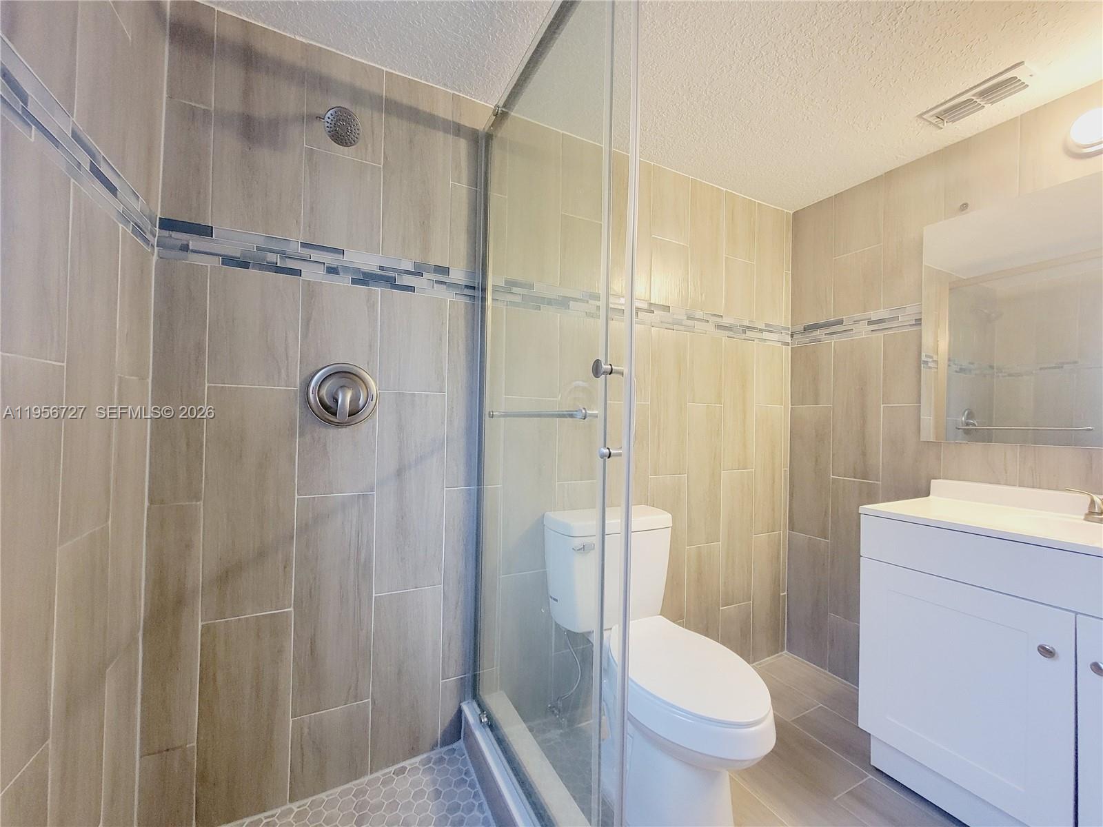 7900 Northwest 50th Street, Unit 108 Lauderhill, FL 33351 - Photo 13 of 18 a bathroom with a sink a toilet and shower