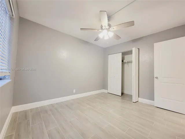 an empty room with fan and a ceiling fan