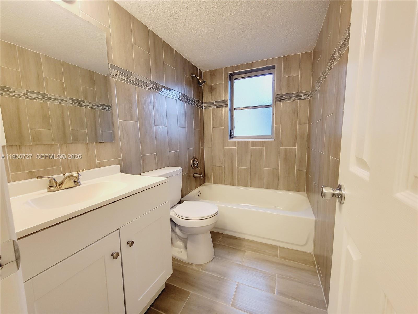 7900 Northwest 50th Street, Unit 108 Lauderhill, FL 33351 - Photo 8 of 18 a bathroom with a sink a toilet and shower