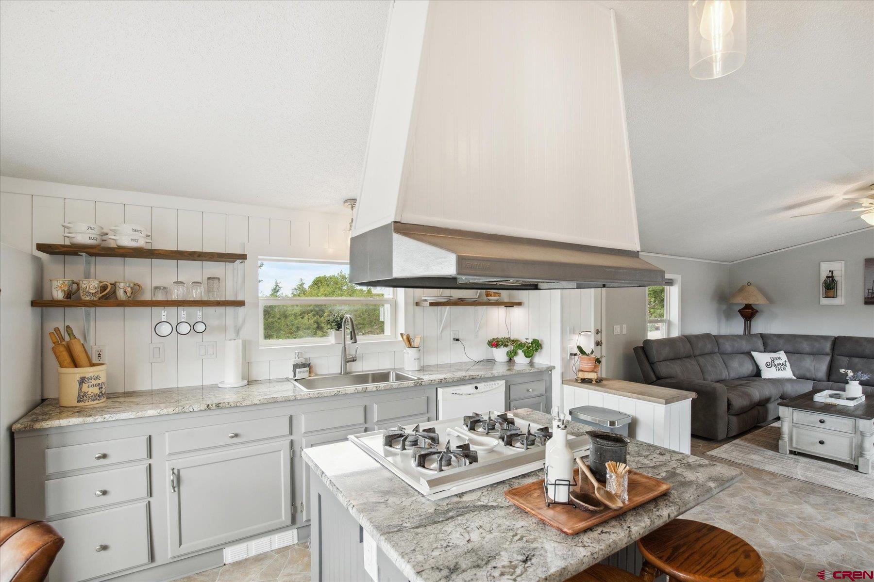 31886 Rd L Mancos, CO 81328 - Photo 12 of 41 a kitchen with stainless steel appliances granite countertop a sink stove and cabinets