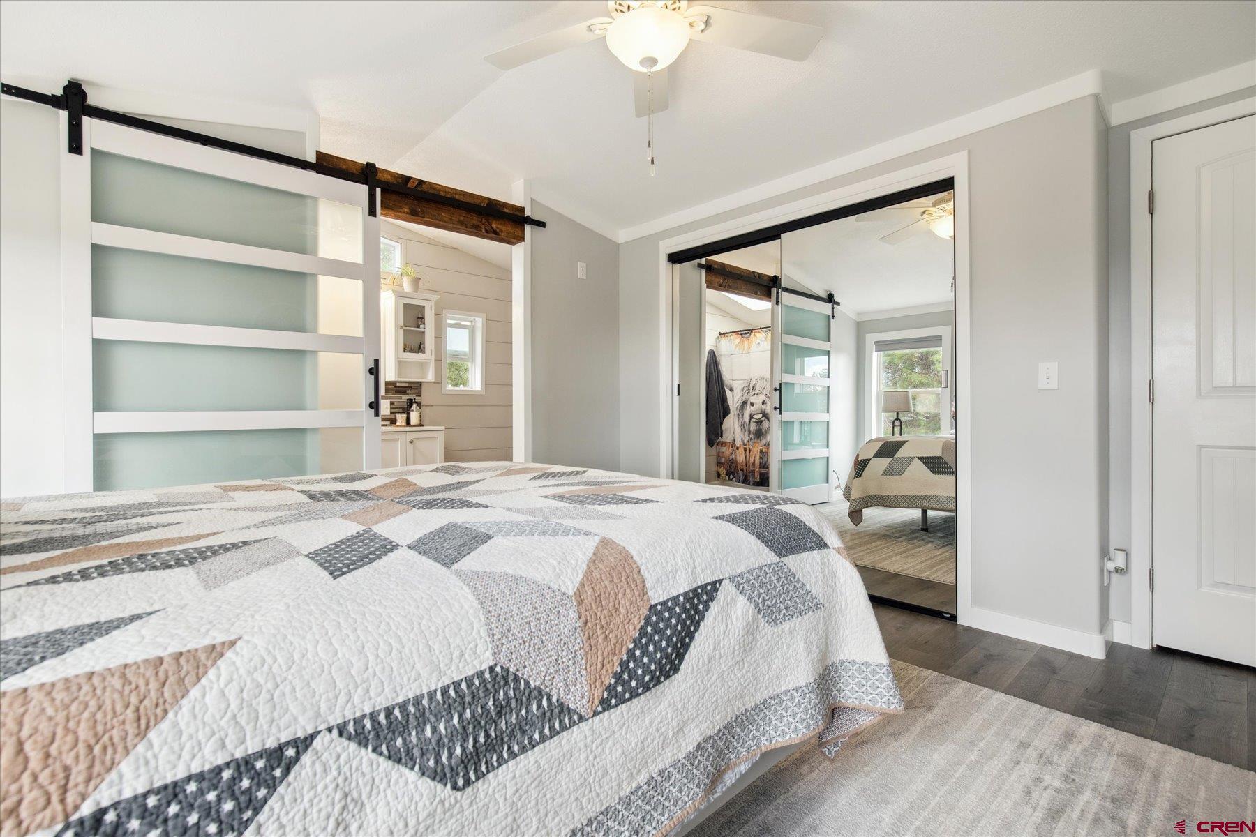 31886 Rd L Mancos, CO 81328 - Photo 19 of 41 a bedroom with a bed and a large mirror with a dresser