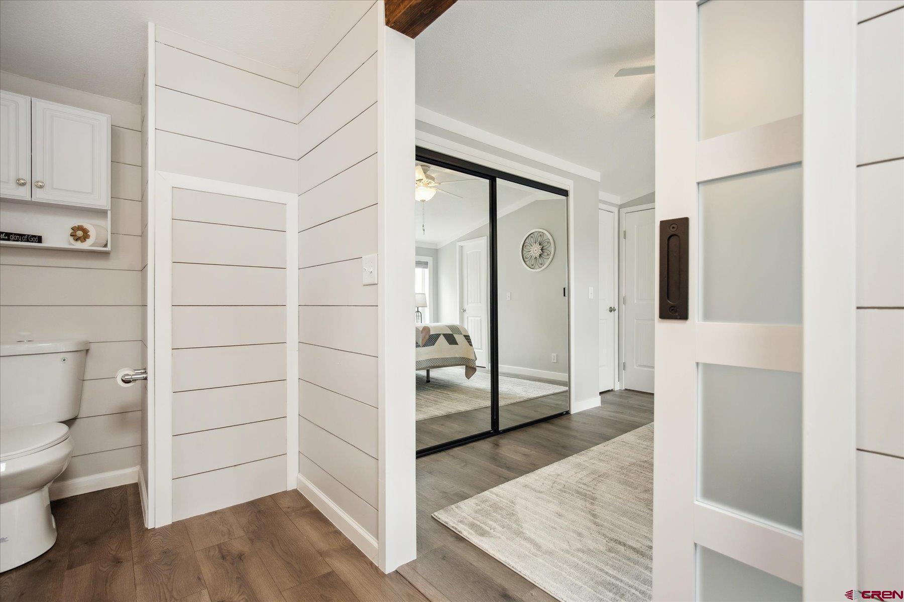 31886 Rd L Mancos, CO 81328 - Photo 22 of 41 a view of walk in closet with wooden floor and bathroom
