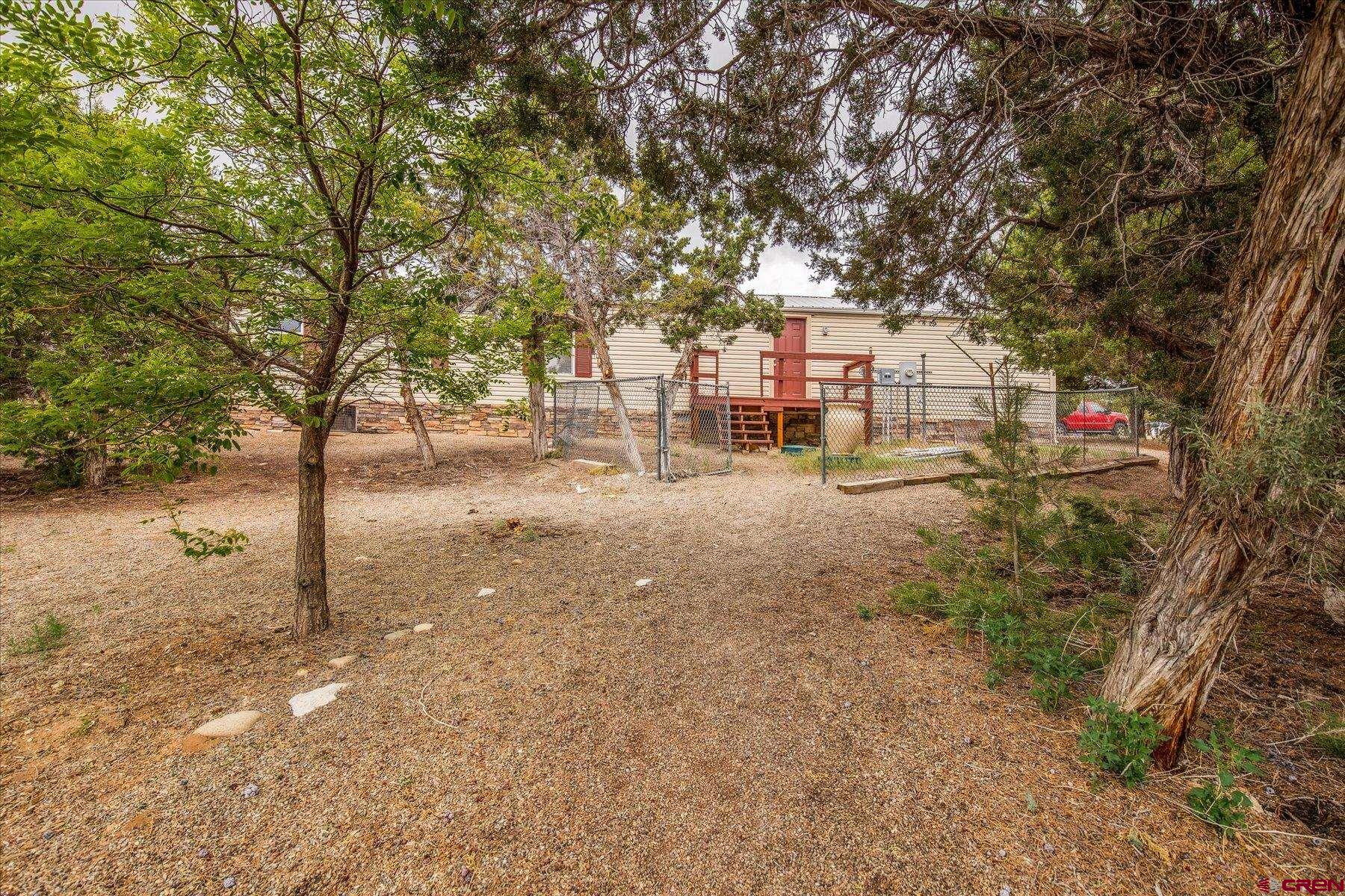 31886 Rd L Mancos, CO 81328 - Photo 30 of 41 a view of a road with large trees