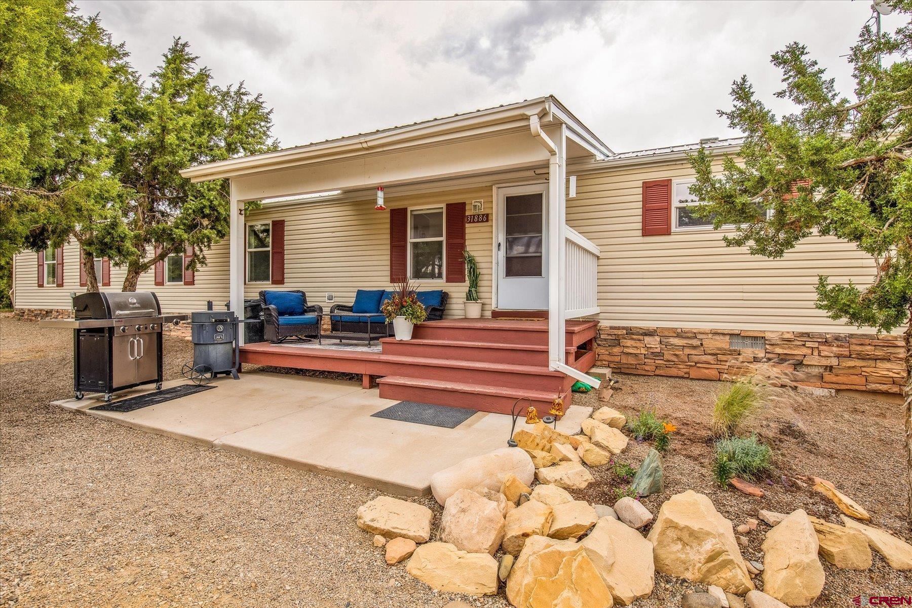 31886 Rd L Mancos, CO 81328 - Photo 31 of 41 a view of a house with backyard and sitting area