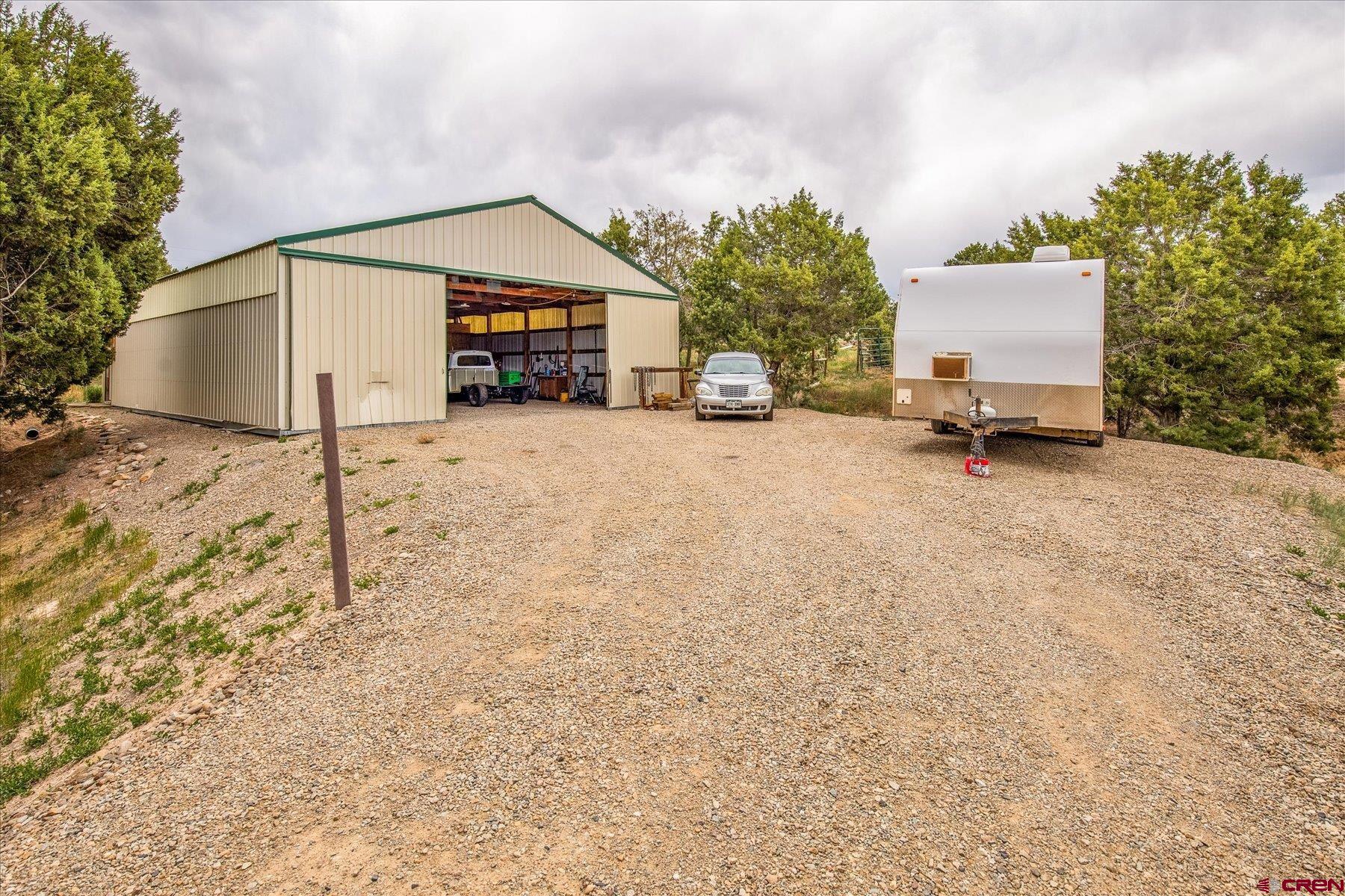 31886 Rd L Mancos, CO 81328 - Photo 38 of 41 a front view of a house with a yard and garage