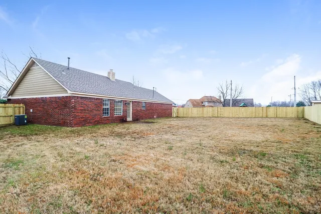 a front view of house with yard and ocean view