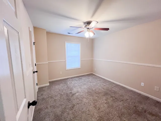 a bathroom with a sink a toilet a mirror and shower